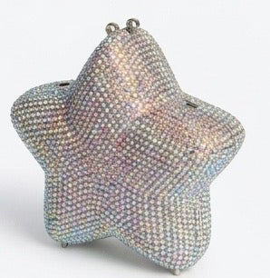 A star-shaped clutch purse covered in iridescent rhinestones, featuring a silver-tone metal top 